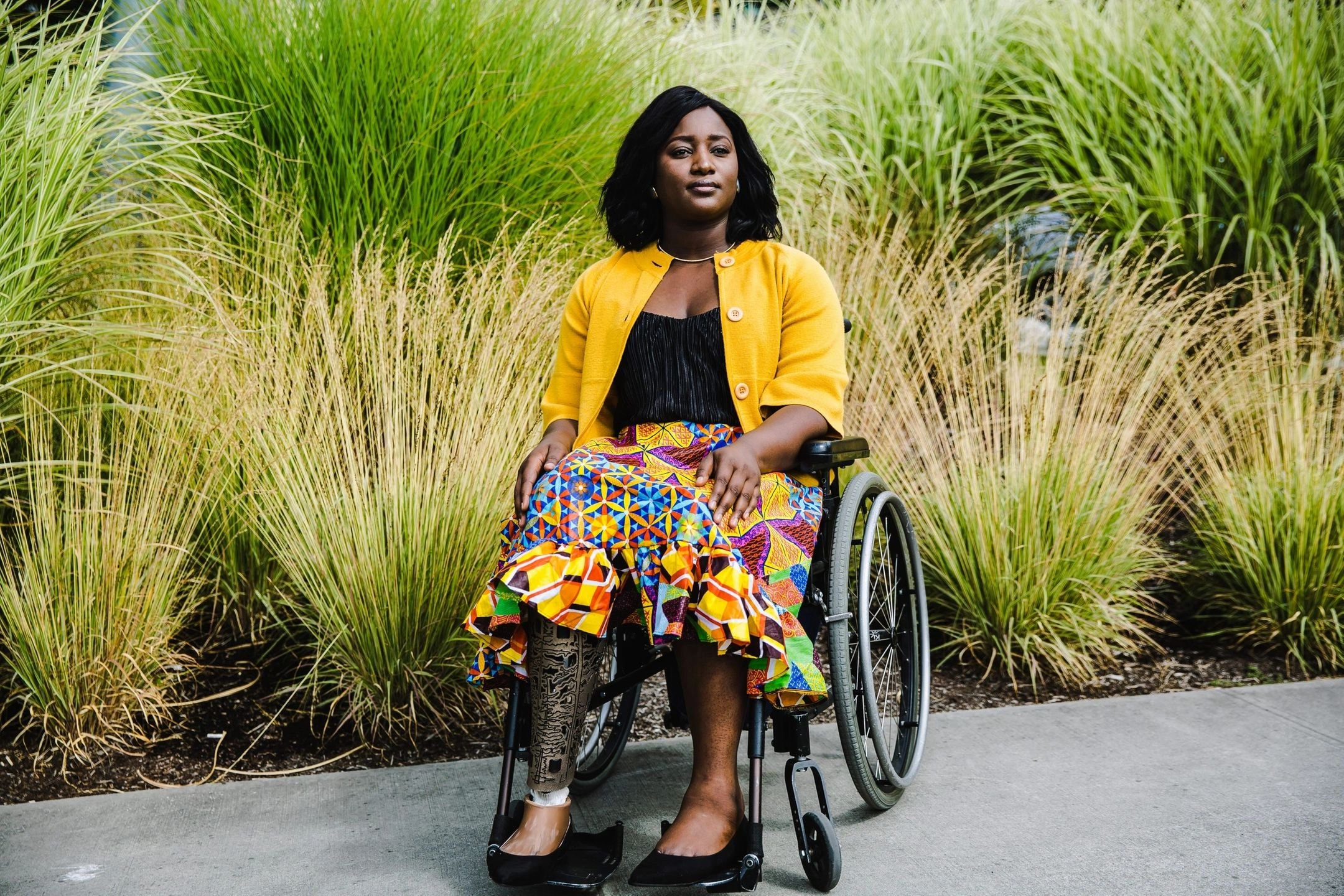 Woman in wheelchair yellow cardigan outdoors